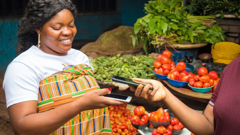 African America Woman Selling Fresh Produce Receiving Payment Mobile Contactless
